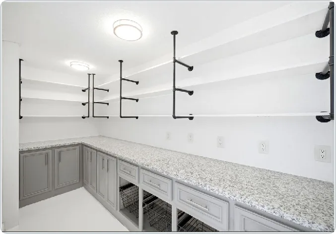 Custom gray storage cabinetry with open shelves and drawers