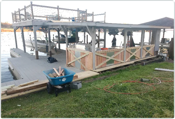 Waterfront construction in progress showing deck framing and stairs