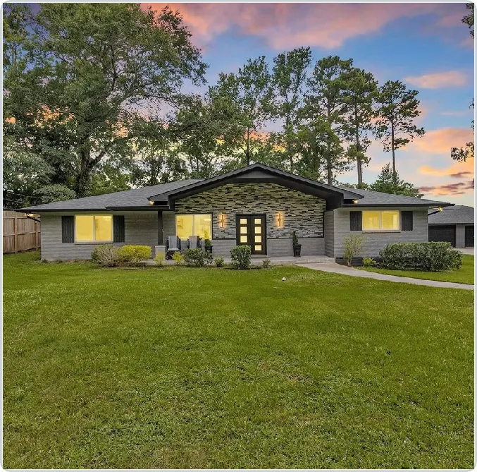 Exterior home remodel with gray finishes, stone accents and an updated front entrance