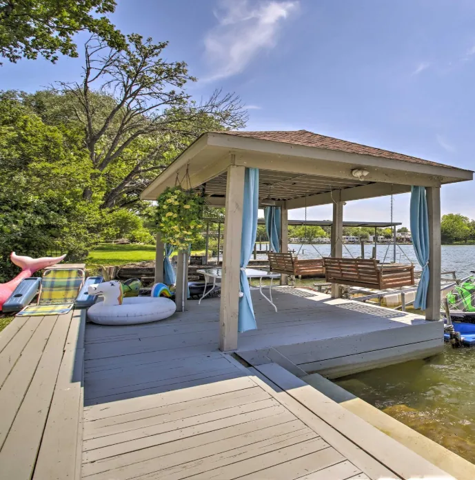 Covered waterfront deck with seating overlooking the water