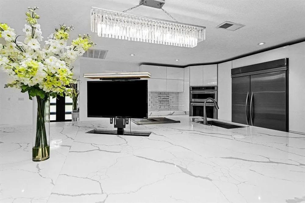 Custom kitchen island with an integrated retractable television