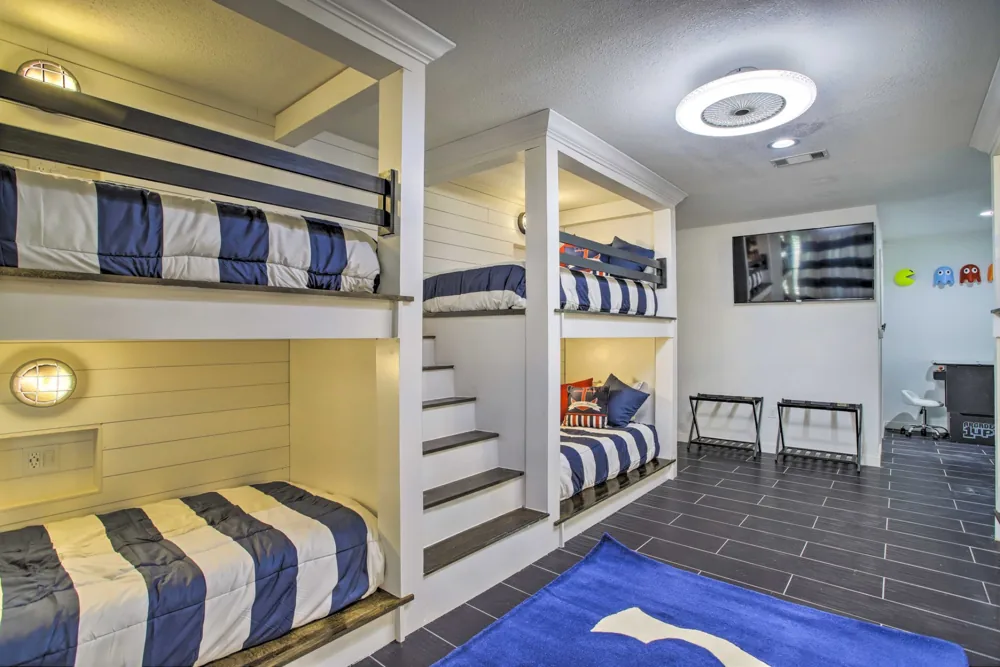 Custom built-in bunk beds with white trim and integrated ladders
